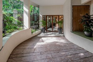 a walkway with plants in pots